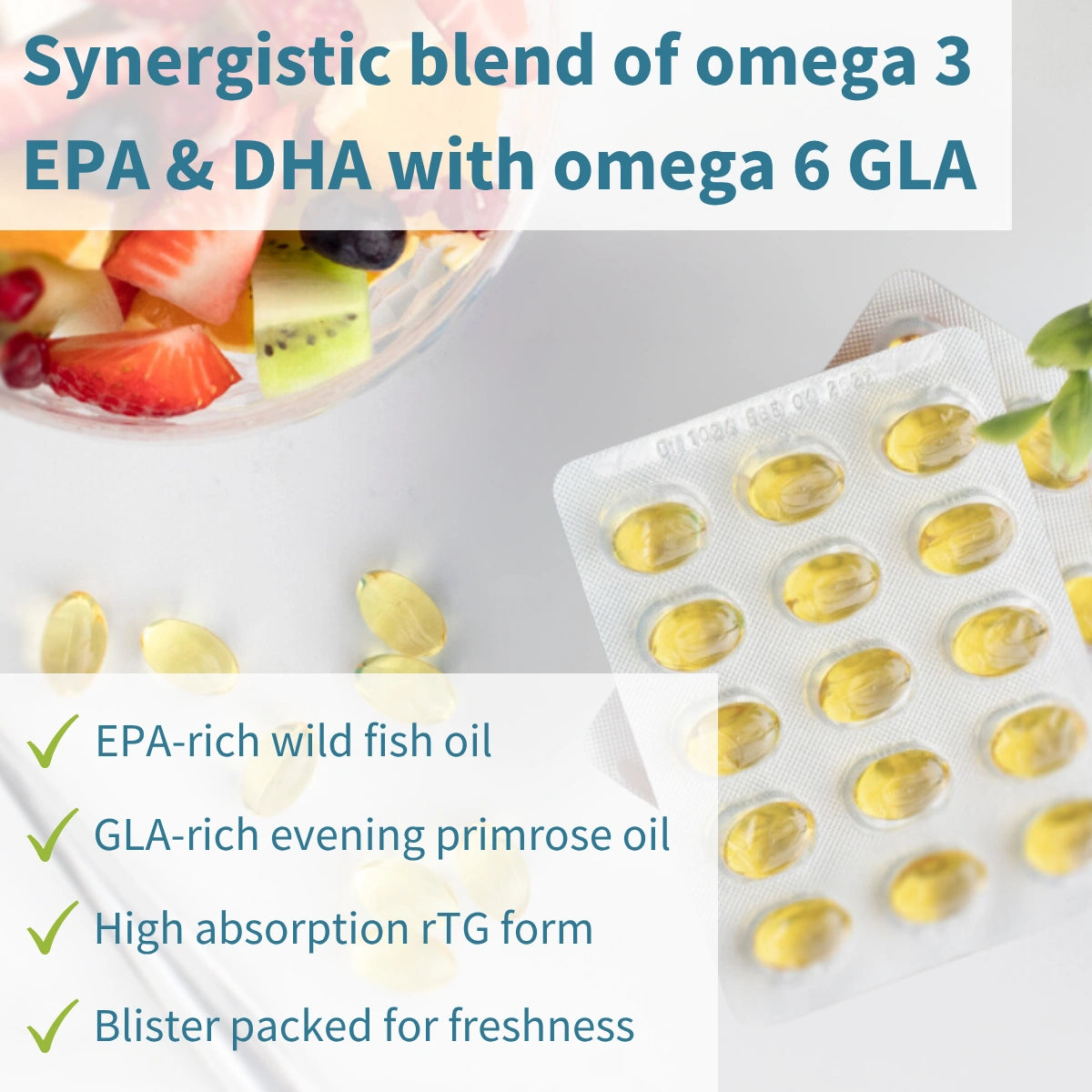 Supplement packaging with fish oil capsules and a bowl of fruit on a white background
