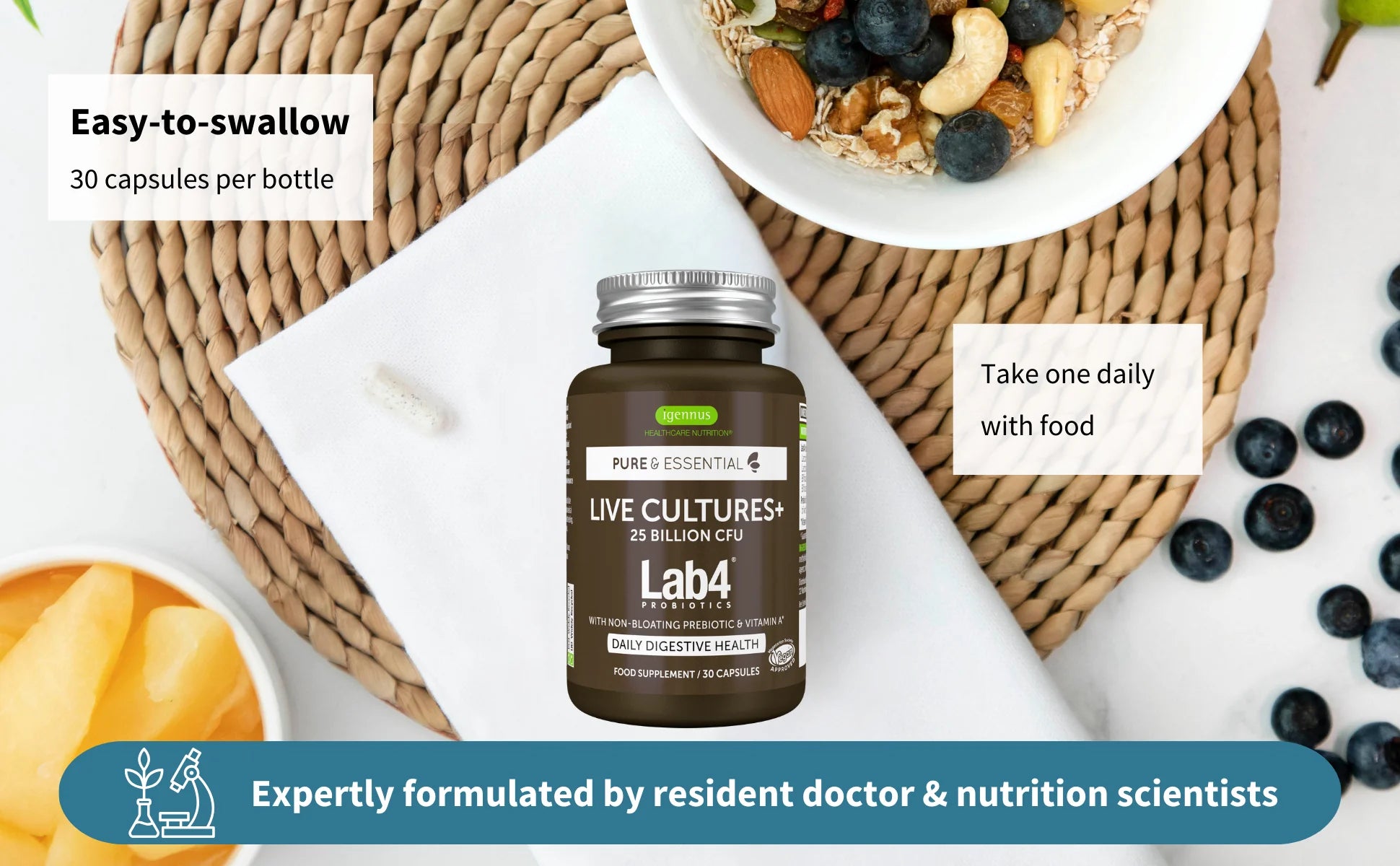 Bottle of Lab4 Essentials supplements with a bowl of fruit and nuts on a woven mat.