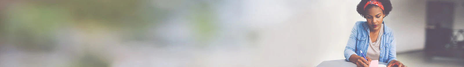Person sitting on a bench with a blurred natural background