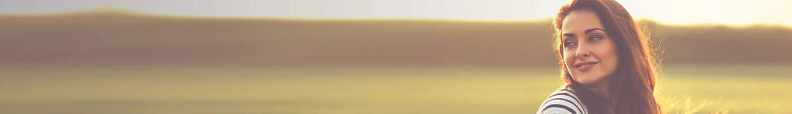 Woman standing in a field with a blurred background