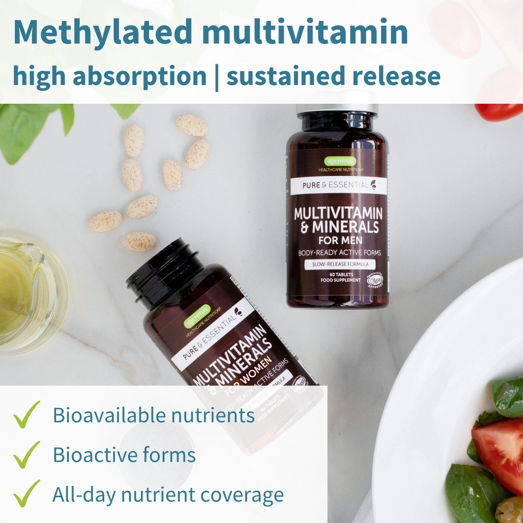 Multivitamin supplement bottles with a salad and vitamins on a white surface