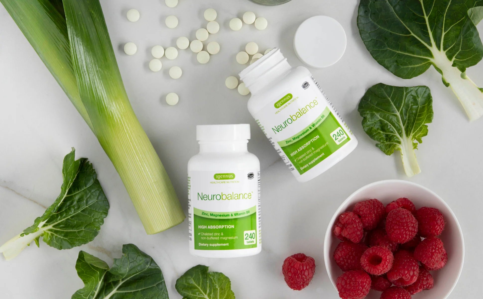 Neurobalance supplements with green vegetables and raspberries on a light background
