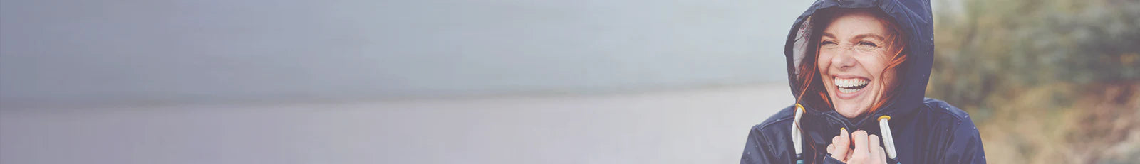 Person wearing a hooded jacket with a blurred background