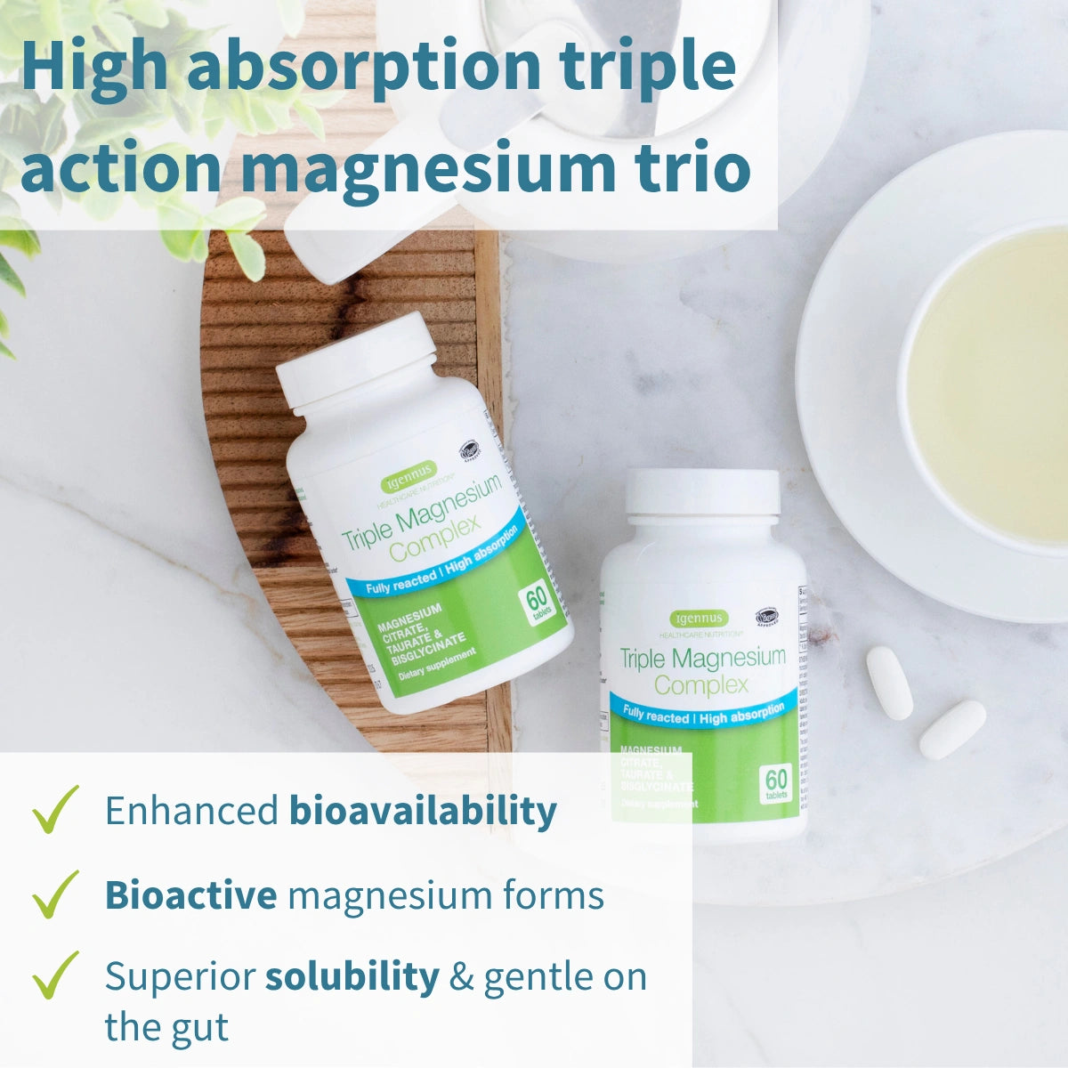 Two bottles of Triple Magnesium Complex on a white surface with tea and a wooden board.