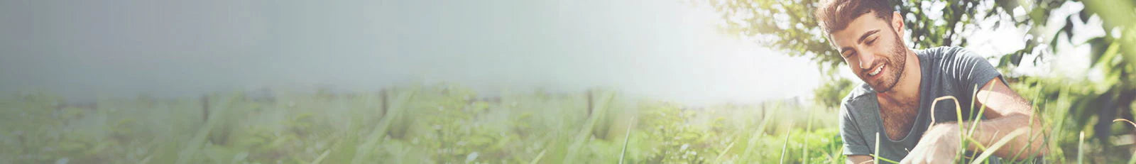Man sitting on grass with a blurred background