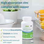 Supplement bottle labeled 'High Absorption Zinc Complex with Copper' on a kitchen counter.
