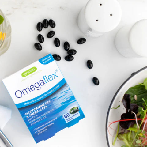 Omegaflex supplement packaging on a white surface with black olives and salad.
