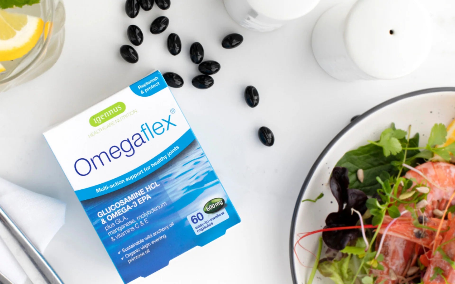 Box of Omegaflex supplement next to a bowl of salad on a white surface