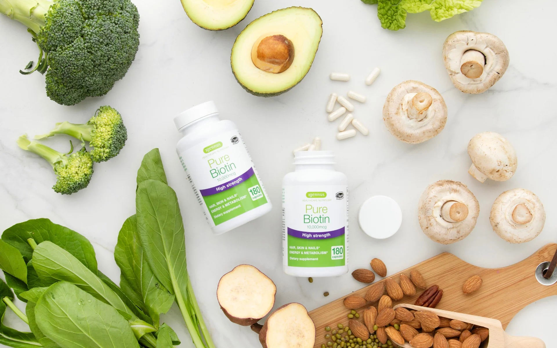 Supplement bottles with fresh vegetables and nuts on a white surface